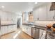 Bright kitchen boasts white cabinets, stainless steel appliances, and modern finishes, offering a clean design at 3361 W 29Th Ave, Denver, CO 80211