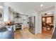 Stylish kitchen features modern stainless steel appliances, white cabinetry, and a view to the dining room at 3361 W 29Th Ave, Denver, CO 80211