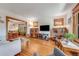 Bright living room featuring hardwood floors, classic woodwork, and an open layout to the dining area at 3361 W 29Th Ave, Denver, CO 80211