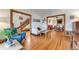 Open-concept living room with hardwood floors, traditional trim, seamlessly connects to the dining room and staircase at 3361 W 29Th Ave, Denver, CO 80211