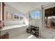 Bright sunroom with multiple windows, white-painted wood paneled walls and ceiling offering natural light and storage at 3361 W 29Th Ave, Denver, CO 80211