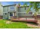 Exterior view of a green two-story house featuring a wooden deck and a lawn at 156 S Lindsey St, Castle Rock, CO 80104