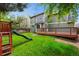 Backyard featuring a playset, grass, and deck, offering space for relaxation and recreation at 156 S Lindsey St, Castle Rock, CO 80104