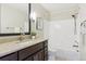 Updated bathroom featuring a vanity with granite countertops, large mirror, and a shower and tub combo at 156 S Lindsey St, Castle Rock, CO 80104