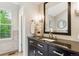 Elegant bathroom features an updated vanity with granite countertops and recessed lighting at 156 S Lindsey St, Castle Rock, CO 80104
