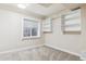 Bright bedroom featuring a window, neutral carpet, and built-in shelving units at 156 S Lindsey St, Castle Rock, CO 80104