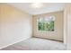 Bedroom features neutral walls, carpeted floors, and a window offering natural light at 156 S Lindsey St, Castle Rock, CO 80104
