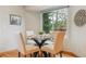 Bright dining area features a glass table, four chairs, and a large window offering views of the outdoors at 156 S Lindsey St, Castle Rock, CO 80104