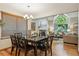 Open dining and living area features hardwood floors, modern chandelier, and an adjoining living room at 156 S Lindsey St, Castle Rock, CO 80104