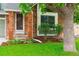 Inviting front entry featuring a red brick facade, steps, and a lush green lawn with mature landscaping at 156 S Lindsey St, Castle Rock, CO 80104