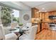 Cozy kitchen features wood cabinets, stainless steel appliances, granite countertops, and a window for ample natural light at 156 S Lindsey St, Castle Rock, CO 80104