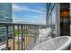 Condo balcony with seating and a view of surrounding buildings and greenery under a blue sky at 1700 Bassett St # 1119, Denver, CO 80202
