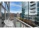 Condo balcony with seating overlooking the swimming pool and surrounding high rise buildings at 1700 Bassett St # 1119, Denver, CO 80202