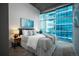 Bright primary bedroom with luxurious bedding, modern decor, and expansive windows with views at 1700 Bassett St # 1119, Denver, CO 80202