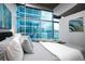 Airy primary bedroom with plush bedding, designer touches, and expansive windows with city views at 1700 Bassett St # 1119, Denver, CO 80202