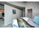 The condo bedroom features a walk-in closet and a view of the kitchen at 1700 Bassett St # 1119, Denver, CO 80202