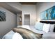 This bedroom features a closet, an ensuite bath, and attractive modern artwork at 1700 Bassett St # 1119, Denver, CO 80202