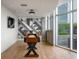 Bright game room with a modern accent wall, wooden floors, and plenty of natural light from the large windows at 1700 Bassett St # 1119, Denver, CO 80202