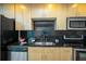 Contemporary kitchen with stainless steel appliances, black backsplash, and ample counter space at 1700 Bassett St # 1119, Denver, CO 80202
