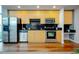 Modern kitchen with stainless steel appliances and sleek black backsplash at 1700 Bassett St # 1119, Denver, CO 80202