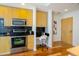 Modern kitchen with stainless appliances and a built-in desk space at 1700 Bassett St # 1119, Denver, CO 80202