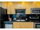 Modern kitchen with stainless steel appliances, black countertops, and sleek cabinetry at 1700 Bassett St # 1119, Denver, CO 80202