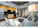 Well-appointed kitchen and living room with stainless steel appliances and modern finishes at 1700 Bassett St # 1119, Denver, CO 80202