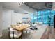 Bright living room with city views through expansive windows at 1700 Bassett St # 1119, Denver, CO 80202