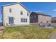 A spacious backyard features a stone patio, a fire pit, seating, and ample space for outdoor enjoyment at 6214 Long Branch Dr, Parker, CO 80134