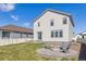 Backyard featuring a patio, fire pit with chairs, and green lawn, ideal for outdoor entertaining at 6214 Long Branch Dr, Parker, CO 80134