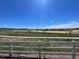 A serene backyard view showcases open space and walking trails, providing a peaceful outdoor experience at 6214 Long Branch Dr, Parker, CO 80134