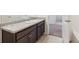Bathroom vanity featuring brown cabinets, light countertop, and access to a separate shower/tub area at 6214 Long Branch Dr, Parker, CO 80134