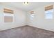 Bright, carpeted bedroom with multiple windows and natural light at 6214 Long Branch Dr, Parker, CO 80134