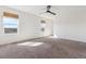 Large, light-filled bedroom with neutral carpet and window views at 6214 Long Branch Dr, Parker, CO 80134
