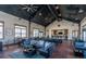 The clubhouse showcases a cozy seating area, tables, and a bar, perfect for social gatherings and relaxation at 6214 Long Branch Dr, Parker, CO 80134
