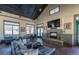A stylish clubhouse featuring a stone fireplace, large TV, and comfortable seating for residents' enjoyment at 6214 Long Branch Dr, Parker, CO 80134