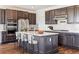 Modern kitchen featuring stainless steel appliances, a large island, and wood floors at 6214 Long Branch Dr, Parker, CO 80134