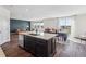 Open kitchen layout with an island that overlooks a dining and living area with expansive windows at 6214 Long Branch Dr, Parker, CO 80134
