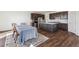 Spacious kitchen with dark cabinets, an island, and adjacent dining area with a large table at 6214 Long Branch Dr, Parker, CO 80134