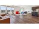 Bright open living space with modern furnishings, wood floors, and large windows offering pleasant views at 6214 Long Branch Dr, Parker, CO 80134