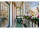 Private balcony with brick wall, bistro table and chairs, and decorative flowers at 45 Jackson St # A, Denver, CO 80206