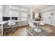 Small dining area with white table and chairs near a window at 45 Jackson St # A, Denver, CO 80206