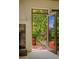Balcony featuring a wrought iron railing and an open door leading to a lush green outdoor view at 8932 Eastridge Rd, Golden, CO 80403