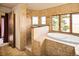 Bright bathroom featuring a soaking tub with scenic views and a tiled walk-in shower at 8932 Eastridge Rd, Golden, CO 80403