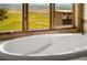 Modern bathtub positioned to capture the amazing panoramic view of lush green landscape and city at 8932 Eastridge Rd, Golden, CO 80403