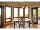 Bright dining area with hardwood floors, bay windows, modern lighting, and an exterior door at 8932 Eastridge Rd, Golden, CO 80403