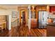 Inviting entryway with hardwood floors and stainless steel refrigerator leading to other rooms at 8932 Eastridge Rd, Golden, CO 80403