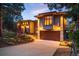 Beautiful home with a lush landscape, large driveway, and garage entrance on a sunny day at 8932 Eastridge Rd, Golden, CO 80403