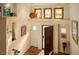 Bright foyer boasts hardwood floors, an open door, transom windows, and decorative wall niches at 8932 Eastridge Rd, Golden, CO 80403