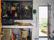 Well-organized garage featuring tools and equipment neatly arranged on a pegboard with access to the outside at 8932 Eastridge Rd, Golden, CO 80403